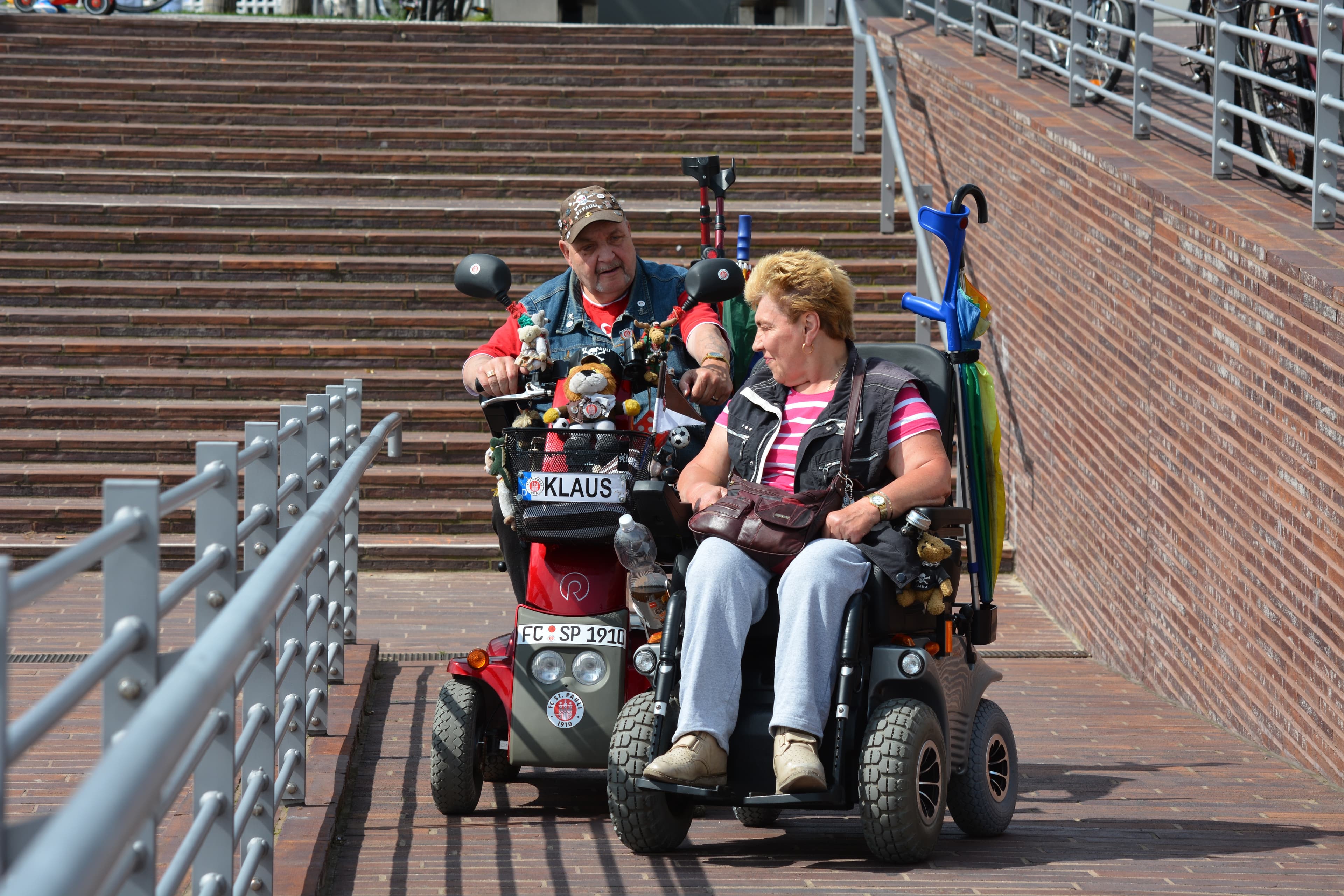 People using mobility scooters on an accessible ramp